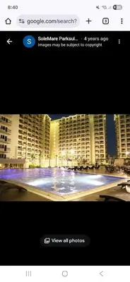 a picture of a large building with a large pool at Solemare Parksuites in Manila