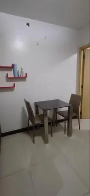 a dining room with a table and chairs at Solemare Parksuites in Manila