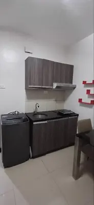 a kitchen with a sink and a stove at Solemare Parksuites in Manila