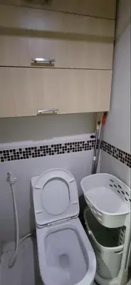 a bathroom with a white toilet and a sink at Solemare Parksuites in Manila