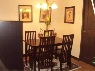 a dining room with a table and four chairs at Tropical Hawaiian 2BR Condo Unit in Metro Manila with Laundry Area - Sleeps 4 in Manila