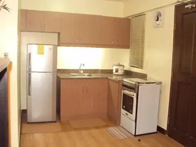 a kitchen with a white refrigerator and a sink at Tropical Hawaiian 2BR Condo Unit in Metro Manila with Laundry Area - Sleeps 4 in Manila