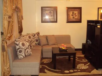 a living room with a couch and a coffee table at Tropical Hawaiian 2BR Condo Unit in Metro Manila with Laundry Area - Sleeps 4 in Manila