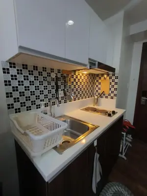 a kitchen with a sink and a counter top at Florian's suite in Air Resideneces Makati in Manila