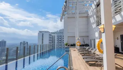 a swimming pool on the roof of a building at Private Apartment walk to Greenbelt, Legazpi Village in Manila