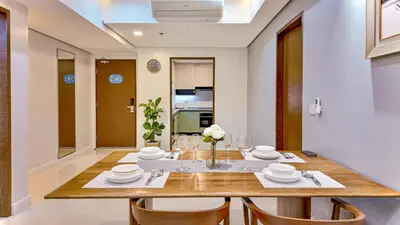 a dining room with a table and chairs at Private Apartment walk to Greenbelt, Legazpi Village in Manila
