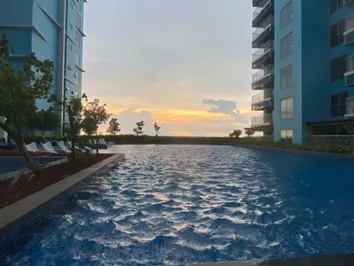 a swimming pool in the middle of two buildings at Modern 1BR with Magnificant Garden View, Near Airports, Okada, Solaire with Free Parking in Manila