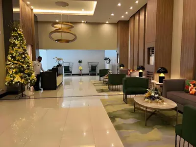a christmas tree in the lobby of a hotel at Modern 1BR with Magnificant Garden View, Near Airports, Okada, Solaire with Free Parking in Manila