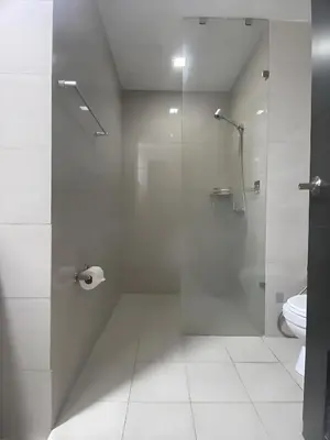 a bathroom with a shower and a toilet at Playful 1BR With Magnificant Bayview Garden View Near Okada Solaire Aiports with Free Parking in Manila