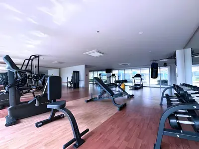 a gym with treadmills and elliptical machines at Playful 1BR With Magnificant Bayview Garden View Near Okada Solaire Aiports with Free Parking in Manila