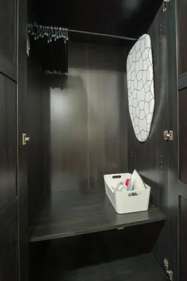 a bathroom with a shelf with a sink and a mirror at Makati Penthouse Studio with City Views in Manila