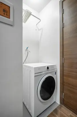 a washer and dryer in a white room at Makati Penthouse Studio with City Views in Manila