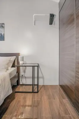 a bedroom with a bed and a glass table at Makati 1BR with Skyline View at Air Residences in Manila