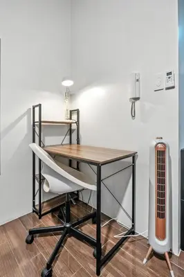a desk and a chair in a room with a radiator at Makati 1BR with Skyline View at Air Residences in Manila