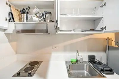 a kitchen with a sink and a counter top at Makati 1BR with Skyline View at Air Residences in Manila