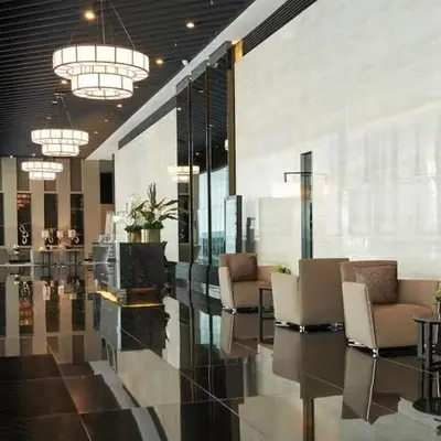 a lobby with chairs and tables in a building at Makati 1BR with Skyline View at Air Residences in Manila