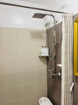 a bathroom with a shower and a toilet at Metro Stay Grand View Tower in Manila