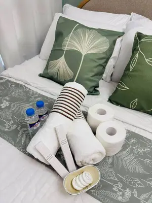 a pile of towels and toiletries on a bed at Metro Stay Grand View Tower in Manila