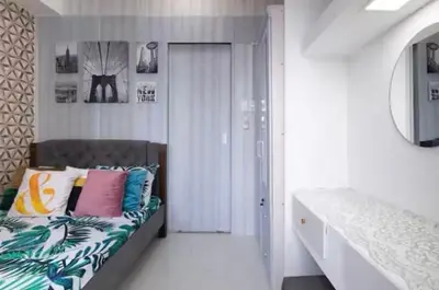 a bedroom with a bed with colorful pillows on it at 1Bed Room Staycation at Green Residences in Manila