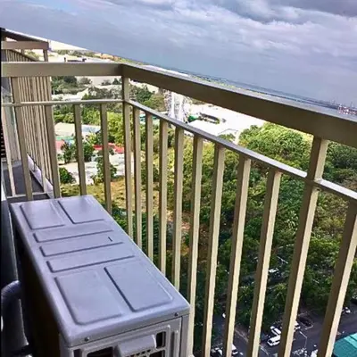 a balcony with a bench and a view of the ocean at Place To Stay Near US Embassy Front Of Manila Bay in Manila