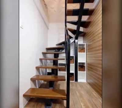 a spiral staircase in a room with wooden floors at NEW AND AFFORDABLE 2BR LOFT at THE FORT BGC 200mbps WiFi in Manila