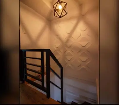 a staircase with a light on a wall with a stair case at NEW AND AFFORDABLE 2BR LOFT at THE FORT BGC 200mbps WiFi in Manila