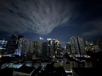 a view of a city skyline at night at Infinity Suites Makati in Manila