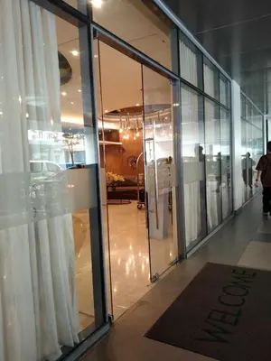 a large glass door in a building with a window at 1 BR- with Balcony -Shore 2 Tw2 - Pasay MOA in Manila