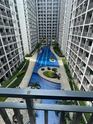a view from the balcony of a building with two tall buildings at Shore 2 Residences Moa Pasay in Manila