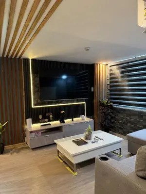 a living room with a couch and a table at 2 bedroom loft type near Rockwell in Manila