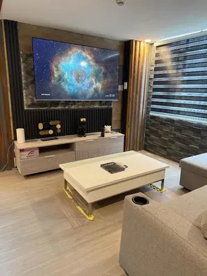a living room with a tv and a coffee table at 2 bedroom loft type near Rockwell in Manila