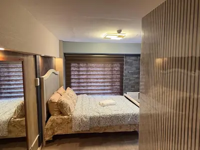 a small bedroom with a bed and a window at 2 bedroom loft type near Rockwell in Manila