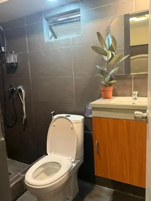 a bathroom with a toilet and a sink at 2 bedroom loft type with 2 baths Near Ortigas Cbd in Manila