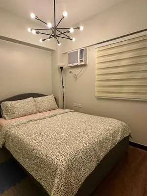 a bedroom with a bed and a ceiling fan at Casa de Caysido in Manila