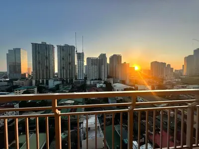 a view of a city skyline with the sun setting at Casa de Caysido in Manila