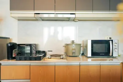 a kitchen with a microwave and appliances on a counter at Upscale Stylish Suite Near BGC and View of Venice Grand Canal Mall in Manila