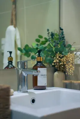 a bottle of soap sitting on top of a bathroom sink at Upscale Stylish Suite Near BGC and View of Venice Grand Canal Mall in Manila