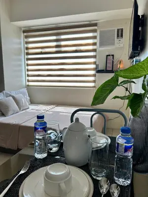 a table with a tea kettle and a plate on it at NIJECRIFIL Condotel in Manila
