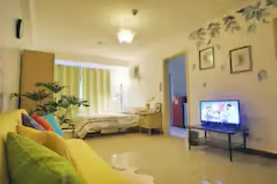 a living room with a couch and a television at 5 mins SM Aura Cozy Studio Type in Manila