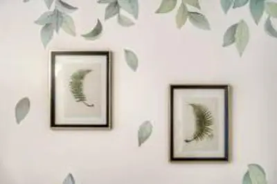 three framed pictures of leaves on a wall at 5 mins SM Aura Cozy Studio Type in Manila