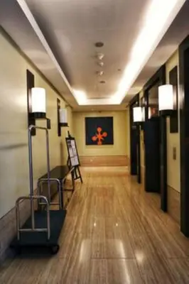 a hallway of a building with a hallwayngth at 5 mins SM Aura Cozy Studio Type in Manila