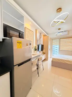 a kitchen and living room with a refrigerator and a bed at Shell Residences Mall of asia Rs in Manila