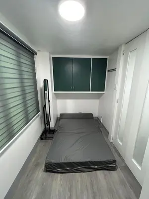 a room with a bed in the corner of a room at Simple but cozy, feel at home in Manila