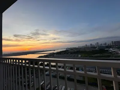 a view of a sunset from a balcony at Seaside Manila Bay Sunset View at SM Mall of Asia in Manila