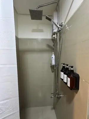 a shower stall with four bottles of soap at Seaside Manila Bay Sunset View at SM Mall of Asia in Manila