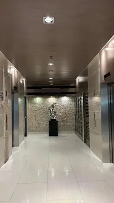 a hallway of a building with a sculpture in the middle at Seaside Manila Bay Sunset View at SM Mall of Asia in Manila