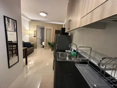 a kitchen with a dish drying rack on the counter at Seaside Manila Bay Sunset View at SM Mall of Asia in Manila