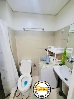 a bathroom with a toilet and a sink at EMZ Shore Staycation 38 in Manila