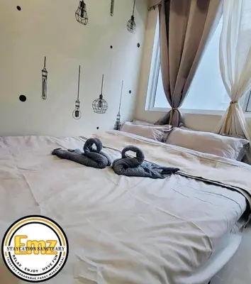 a bed with two snakes laying on top of it at EMZ JAZZ Staycation in Manila