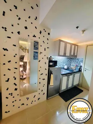 a kitchen with a wall covered in black butterflies at EMZ JAZZ Staycation in Manila